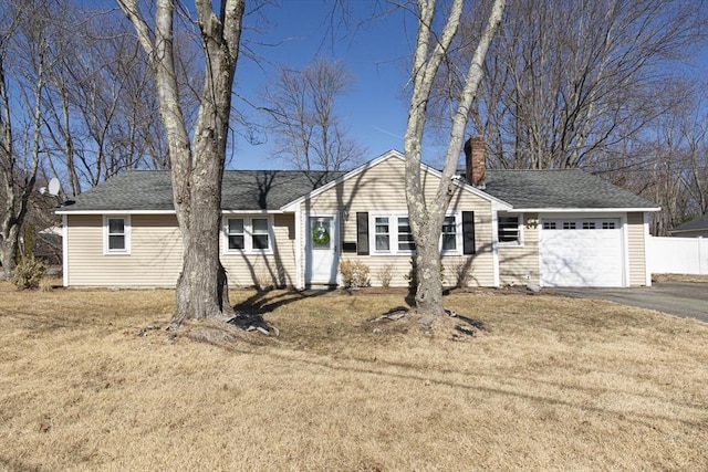 single story home with a front lawn, fence, aphalt driveway, a chimney, and a garage