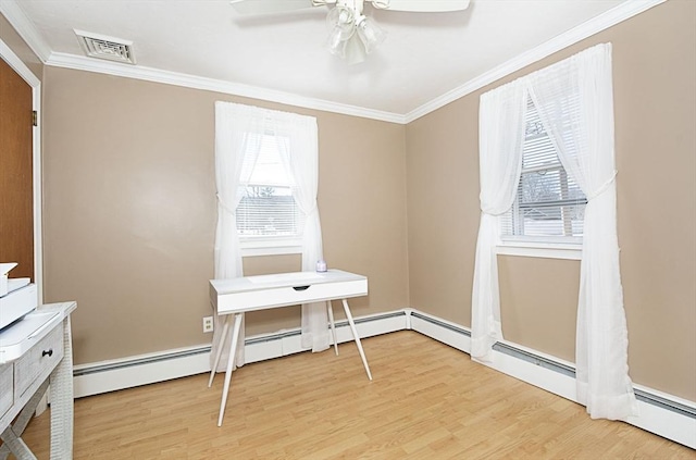 office area featuring plenty of natural light, light wood-style flooring, crown molding, and visible vents