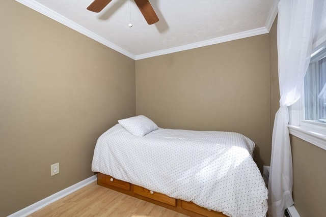 bedroom featuring ornamental molding, a ceiling fan, baseboards, and wood finished floors