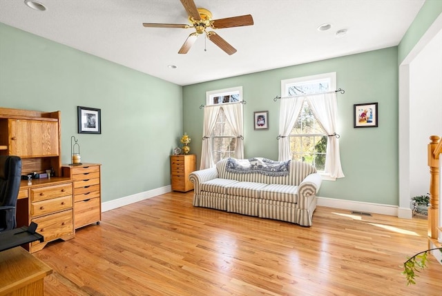 sitting room with a ceiling fan, baseboards, recessed lighting, and light wood-style flooring