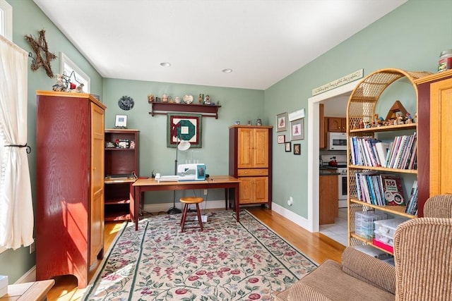 office space with light wood-style floors, baseboards, and recessed lighting