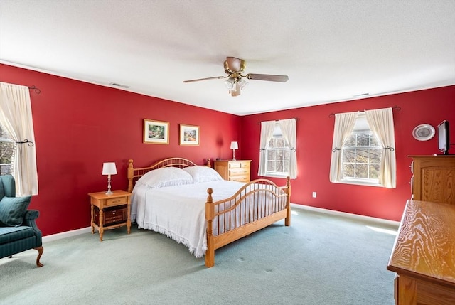 bedroom featuring baseboards, ceiling fan, carpet flooring, and visible vents