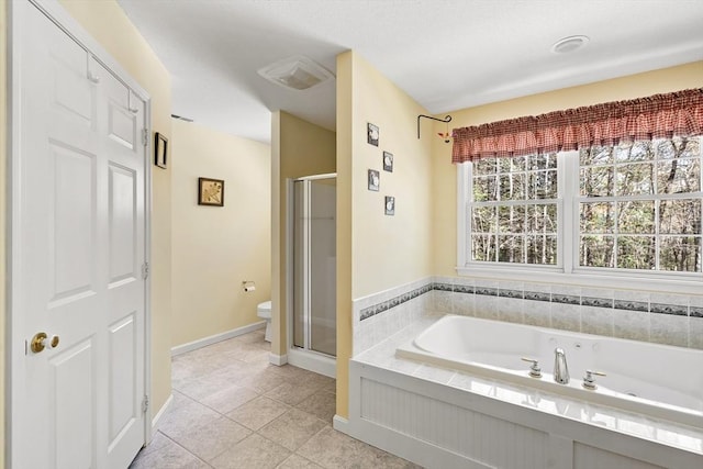full bathroom with tile patterned floors, a shower stall, toilet, and a garden tub