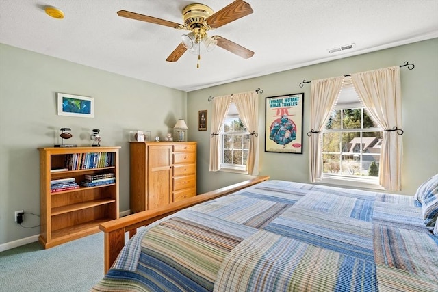 bedroom featuring visible vents, carpet flooring, baseboards, and multiple windows
