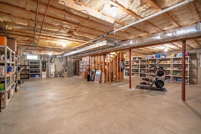 unfinished basement featuring heating unit and gas water heater