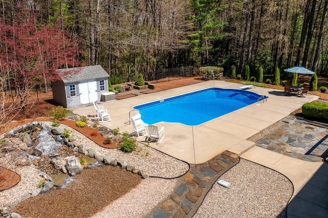 outdoor pool featuring an outdoor structure, a patio area, and fence