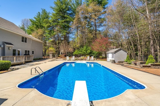 outdoor pool with an outdoor structure, a patio area, a storage shed, and a deck