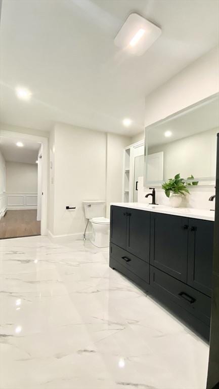 bathroom featuring vanity and toilet