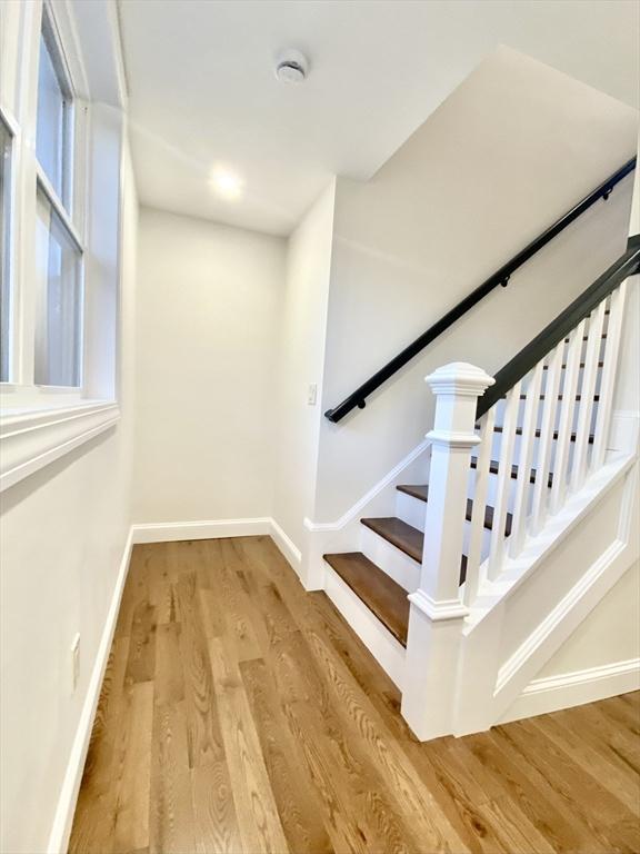 stairs with wood-type flooring