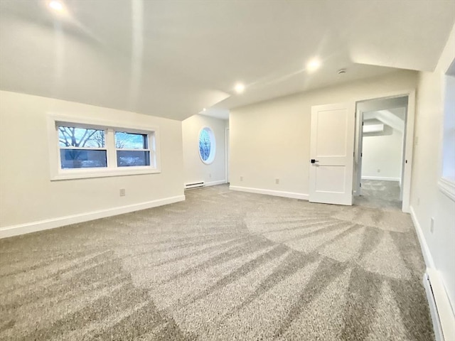 bonus room with baseboard heating and carpet