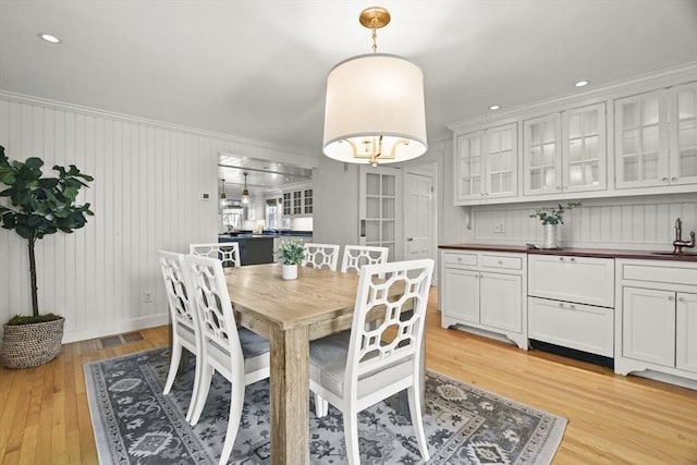 15 Alden Rd, Wellesley, MA 02481 - dining area with light wood-style floors, crown molding, and baseboards