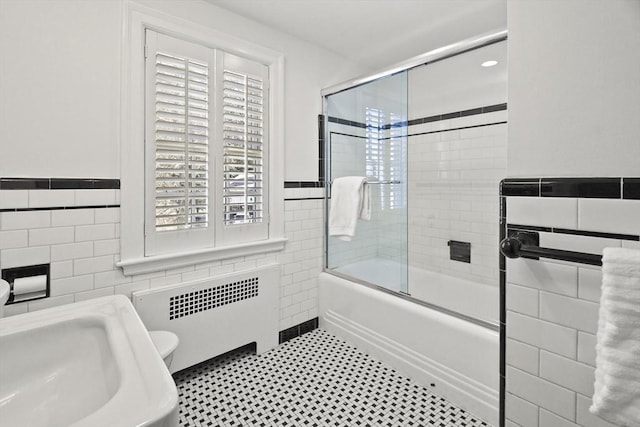 15 Alden Rd, Wellesley, MA 02481 - bathroom featuring tile walls, radiator, enclosed tub / shower combo, a sink, and wainscoting