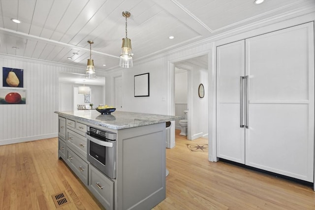 15 Alden Rd, Wellesley, MA 02481 - kitchen with gray cabinetry, stainless steel oven, crown molding, light wood-type flooring, and a kitchen island