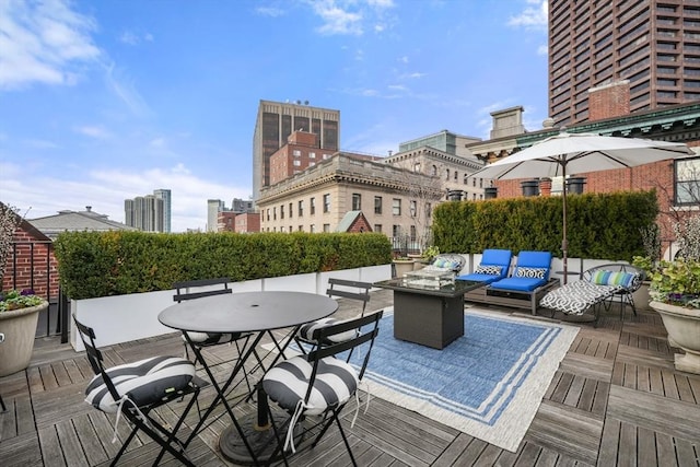 deck featuring an outdoor living space with a fire pit