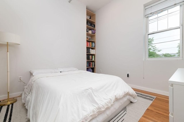 960 Broadway Unit 10, Chelsea, MA 02150 - bedroom featuring light wood finished floors and multiple windows