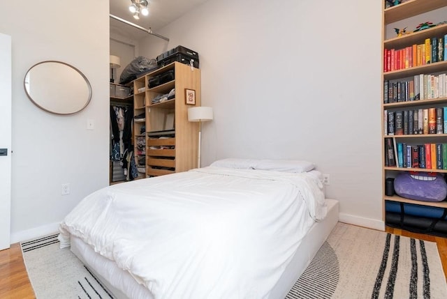 960 Broadway Unit 10, Chelsea, MA 02150 - bedroom featuring wood finished floors, a closet, and a walk in closet