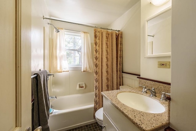 bathroom with toilet, shower / bath combination with curtain, a wainscoted wall, and vanity