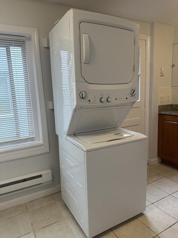 994 Washington St Unit 2, Weymouth, MA 02189 - laundry room with stacked washer and clothes dryer, light tile patterned flooring, and healthy amount of natural light