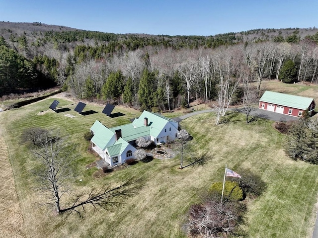 drone / aerial view featuring a wooded view