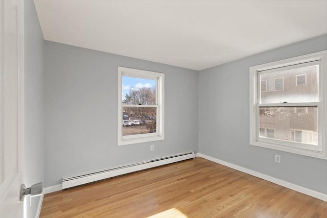 spare room featuring light hardwood / wood-style flooring and a baseboard radiator