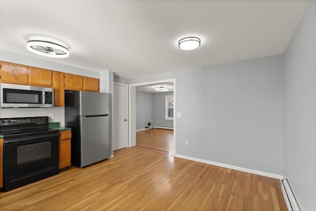 kitchen featuring stainless steel appliances, a baseboard radiator, and light wood-type flooring