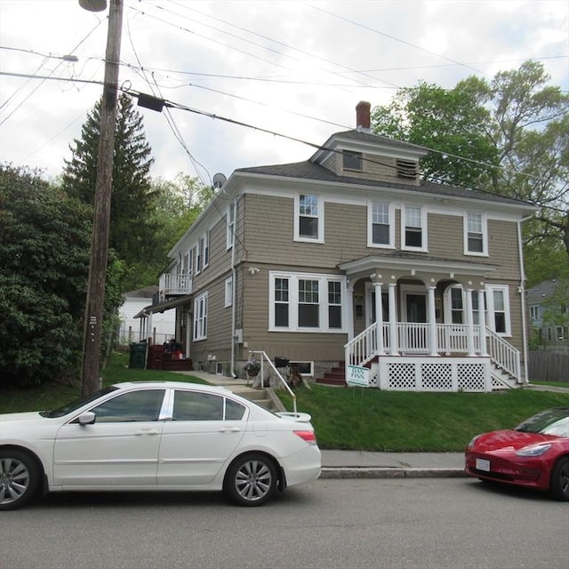 85-87 Belrose Ave, Lowell, MA 01852 - traditional style home with covered porch, a chimney, and a front lawn