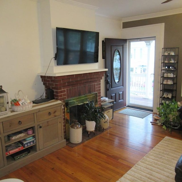 85-87 Belrose Ave, Lowell, MA 01852 - foyer featuring wood finished floors, crown molding, and a brick fireplace