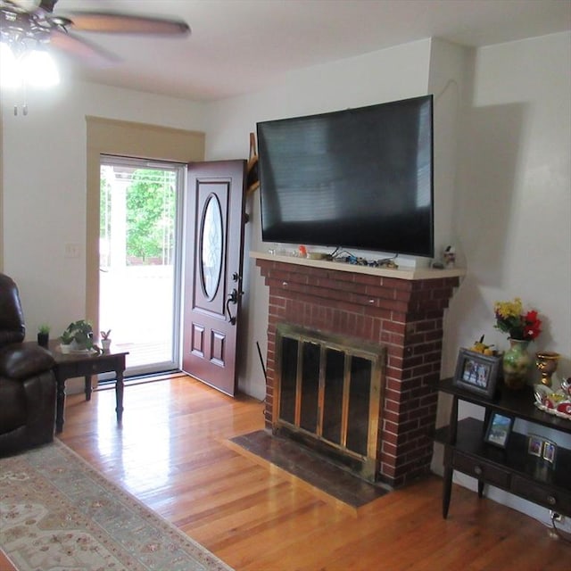 85-87 Belrose Ave, Lowell, MA 01852 - living room featuring wood finished floors, a ceiling fan, and a brick fireplace