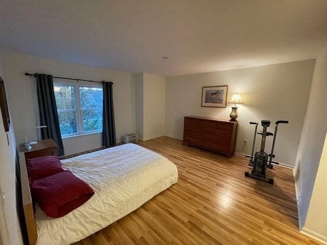 bedroom with wood finished floors and baseboards