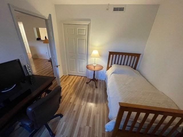 bedroom featuring wood finished floors and baseboards