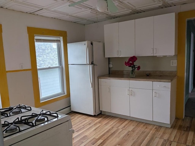 15 10th, Lowell, MA 01850 - kitchen with white appliances, white cabinets, light countertops, light wood-style flooring, and an ornate ceiling