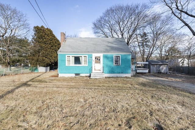 bungalow-style home with a front yard