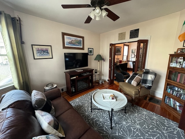 living room with hardwood / wood-style floors and ceiling fan