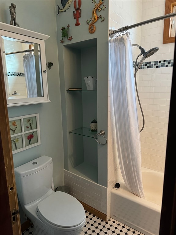 bathroom featuring toilet and shower / tub combo with curtain