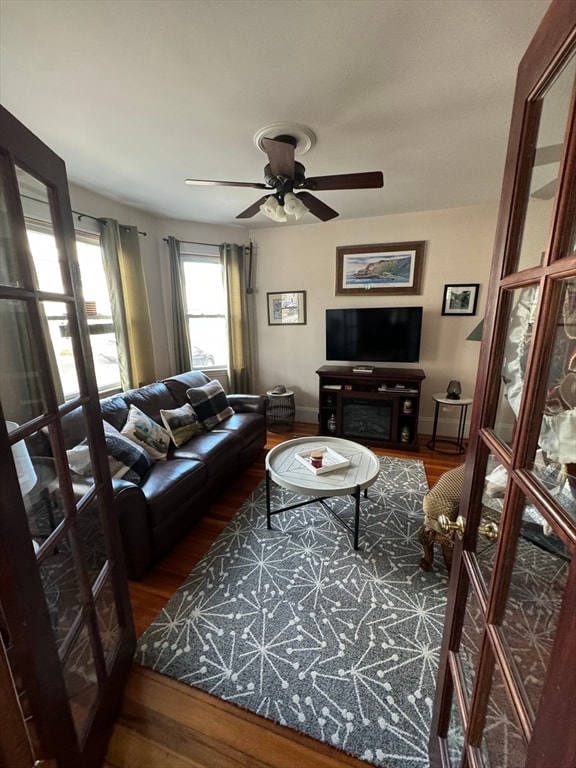 living room with hardwood / wood-style floors and ceiling fan