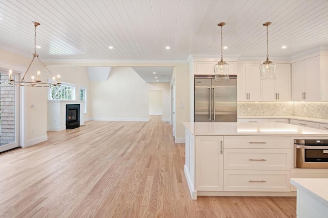 1 Wilsons Ln, Edgartown, MA 02539 - kitchen featuring stainless steel appliances, light countertops, a chandelier, wood ceiling, and open floor plan