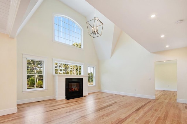 1 Wilsons Ln, Edgartown, MA 02539 - unfurnished living room with high vaulted ceiling, a chandelier, light wood-style floors, healthy amount of natural light, and recessed lighting