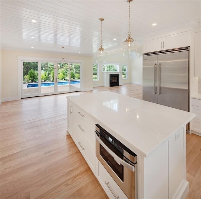 1 Wilsons Ln, Edgartown, MA 02539 - kitchen with open floor plan, light wood-style floors, plenty of natural light, stainless steel built in refrigerator, and recessed lighting