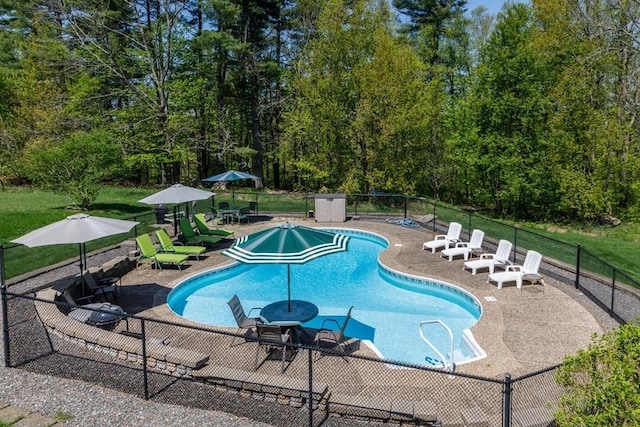 view of pool featuring a patio and fence