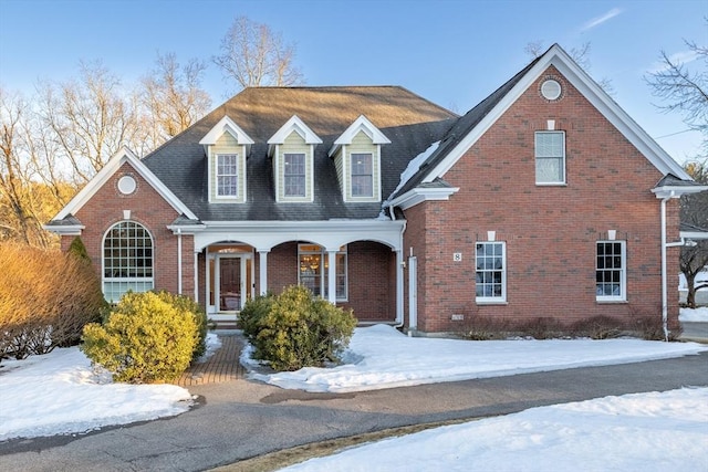 view of front facade with covered porch and brick siding