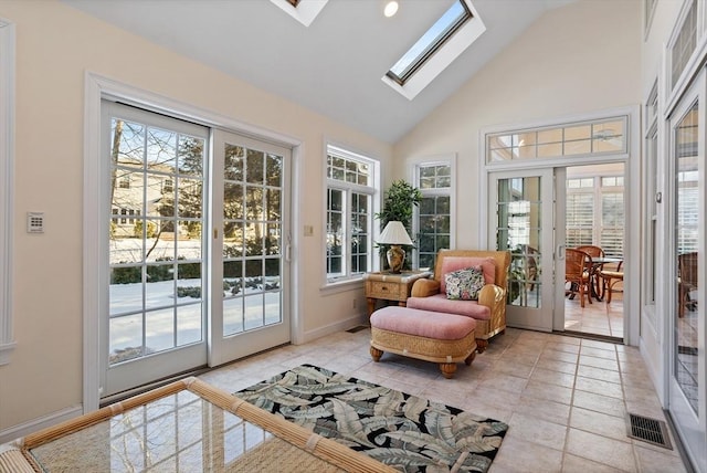 sunroom with lofted ceiling with skylight, french doors, and visible vents