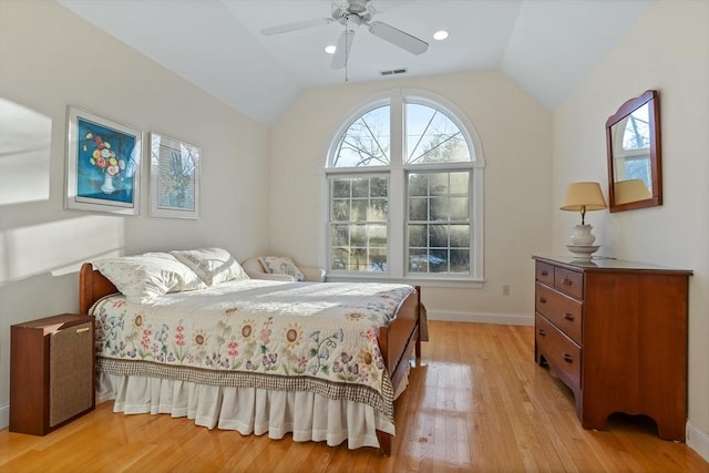 bedroom with visible vents, vaulted ceiling, ceiling fan, light wood-type flooring, and baseboards