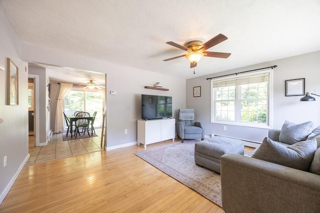 19 Crystal Way Unit 19, Bellingham, MA 02019 - living room featuring ceiling fan, healthy amount of natural light, a baseboard radiator, and hardwood / wood-style floors