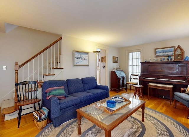 living area featuring stairway and wood finished floors