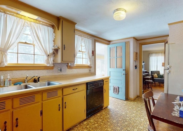 kitchen featuring black dishwasher, freestanding refrigerator, light countertops, light floors, and a sink