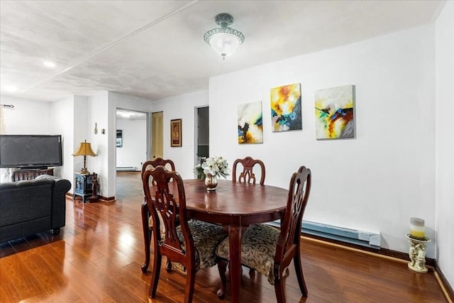 dining area with baseboard heating and wood finished floors
