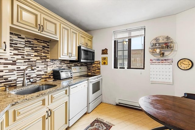 kitchen featuring white appliances, cream cabinetry, a sink, a baseboard radiator, and tasteful backsplash