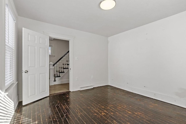 spare room with a wealth of natural light and baseboard heating