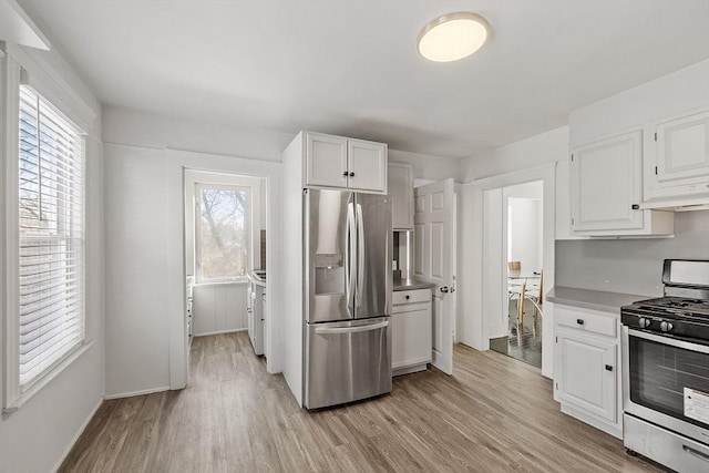 kitchen featuring white cabinetry, light hardwood / wood-style flooring, and stainless steel appliances