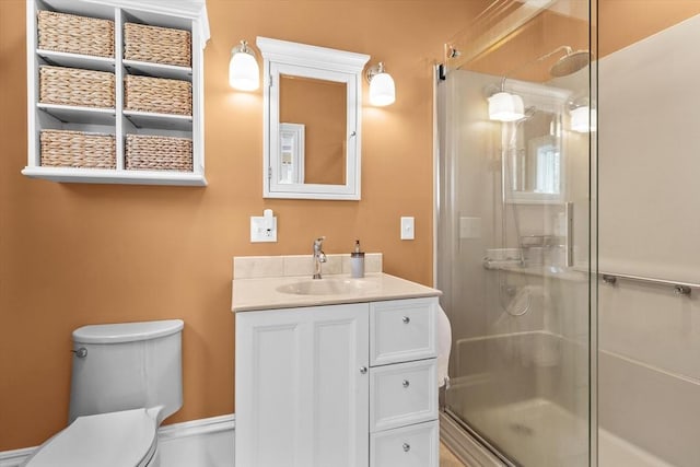 full bath featuring vanity, toilet, and a shower stall